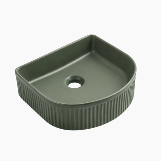 Green ceramic sink basin with ribbed design on a white background